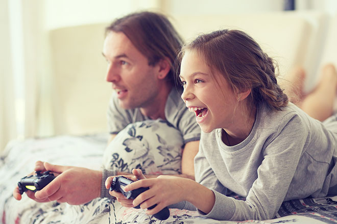 padre e figlia che giocano ai videogames